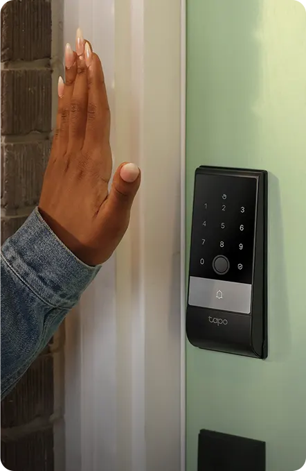 An open palm held in front of a smart lock's sensor
